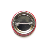 back of a metal pinback button