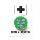 A round green pinback button that reads CLIMATE ACTION NOW in white text  with a 3D graphic effect. Button is on a SOCIAL ALERT BUTTON backing card.