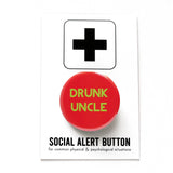 Round red 1.25" pinback button that reads DRUNK UNCLE in light green text. Badge is on a Social Alert Button backing card.