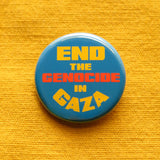 A round blue pinback button that reads END THE GEN0CIDE IN GAZA in yellow & orange bold text. Pinned to a goldenrod yellow cotton fabric.