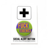 a round 1.25" pinback button with a lime green grid pattern background that reads  FUCK EUGENICS in golden yellow text with purple rectangles behind. Button is on a Social Alert Button backing card.