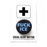 a round black button that says FUCK ICE in a chunky light blue font. Button is on a Social Alert Button backing card.