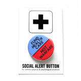 A round pinback button split between two colors, hospital scrubs blue on the top and neon Advil red-orange on the bottom. The top of the button reads: FUND HEALTHCARE, The bottom reads: NOT WARFARE.  Badge is on a Social Alert Button backing card.