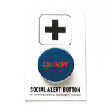 Dark navy blue round pinback button that reads GRUMPY in a red-orange font. Button is on a Social Alert Button backing card.