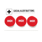 3 round red pinback buttons lined up on a SOCIAL ALERT BUTTONS backing card. Reading left to right: Ho! Ho! Ho! 