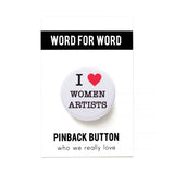Round white pinback button that reads I LOVE WOMEN ARTISTS with a red heart indicating love. Button is on a Word For Word Pinback Button branded backing card.