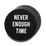 A stack of round black stickers that reads NEVER ENOUGH TIME in white san serif text.  