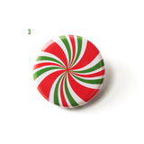 A red, green & white pinwheel spiral pinback button that looks like a peppermint candy. a number 3 in green indicates Design 03