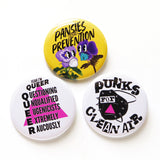 Three round colorful 2.25" pinback buttons with a queer covid conscious theme that advocate for masking, clean air & anti-eugenics