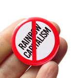 A round white button that reads NO TERFS in black text with a red circle and slash to indicate being against RAINBOW CAPITALISM Button is held in a hand.