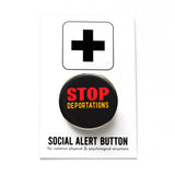 Round black pinback button that reads: STOP DEPORTATIONS in red and yellow text. The button is pinned to a Social Alert Button backing card.