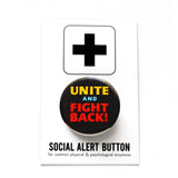 A round black pinback button that reads UNITE AND FIGHT BACK! in yellow, blue and red type. Button is on a SOCIAL ALERT BUTTON backing card.