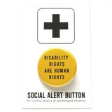 Round, golden yellow pinback button reads: Disability Rights are Human Rights in san serif capital letters. Button is on a white Social Alert Button backing card with a black plus sign at the top.