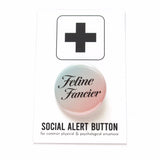 round pinback button that is mint green to peachy-pink ombre with serif black text reading Feline Fancier. Button is on top of a white backing card with a black plus sign at the top, reading Social Alert Button at the bottom