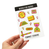 A sheet of feminist themed stickers in yellow, moss green pink and orange. Phrases include Feminist With A To-Do List, Equal Pay, The Personal Is Political, Patriarchy Is A plague, A Woman's Work   Is Never Done, Intersectional and little women's symbol stickers. Sticker Sheet is held up by a hand.