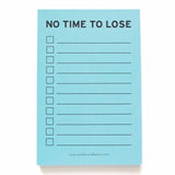 Light blue 4x6" inch notepad. Reads NO TIME TO LOSE at the top in a black sans serif font.  Eleven check boxes line the left side of the page, with lines to write your task on the write. Small text listing word for word factory's website www.wordforwordfactory.pro at the bottom.