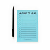 Light blue 4x6" inch notepad. Reads NO TIME TO LOSE at the top in a black sans serif font. Eleven check boxes line the left side of the page, with lines to write your task on the write. Small text listing word for word factory's website www.wordforwordfactory.pro at the bottom.