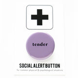 A round lavender 1.25" pinback button that reads tender in small, lower case black text. Button is on a Social alert Button backing card.