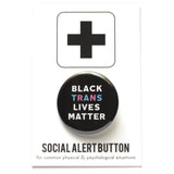 Round pinback button that says BLACK TRANS LIVES MATTER. White, light blue and light pink text on a black background. Button is on a Social alert button backing card.